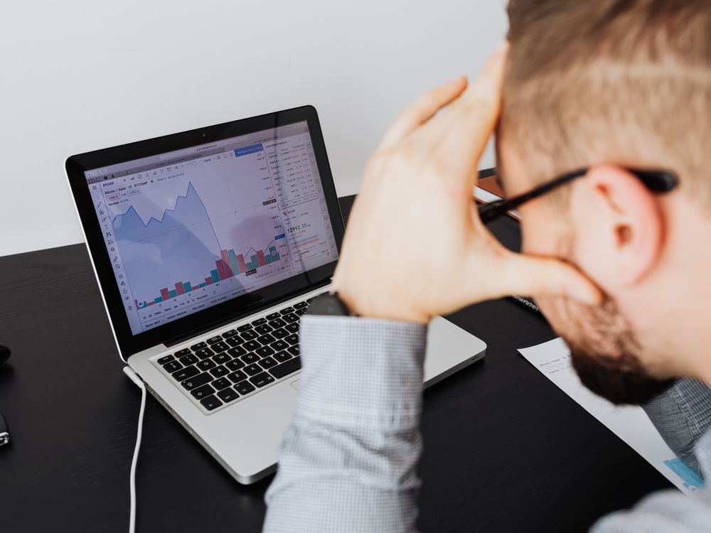 Business owner reviewing marketing performance data without clear answers
